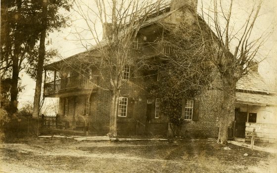 sepia tone image of an old stone house
